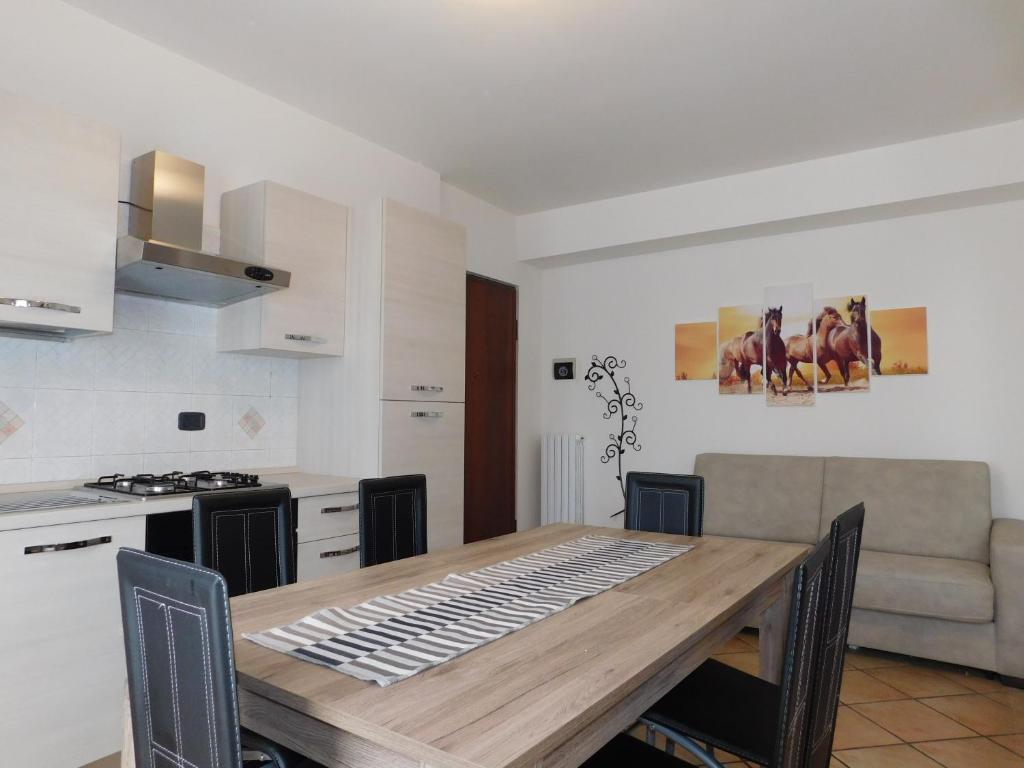 a kitchen and dining room with a wooden table at Residenza Meeting in Verona