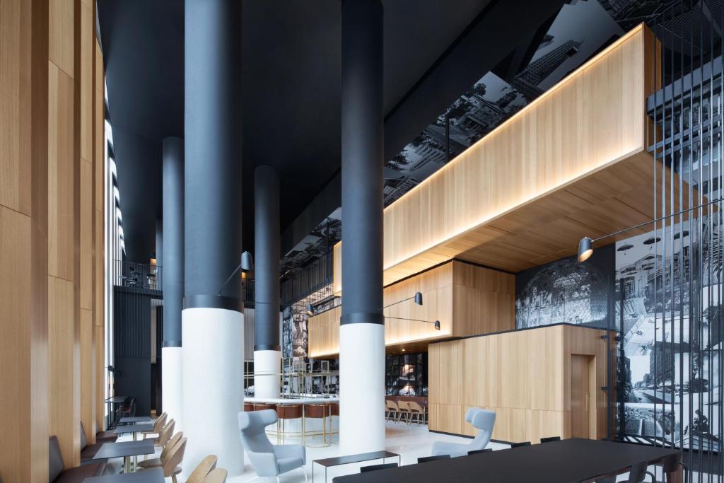 a rendering of a restaurant with tables and chairs at Hotel Monville in Montréal