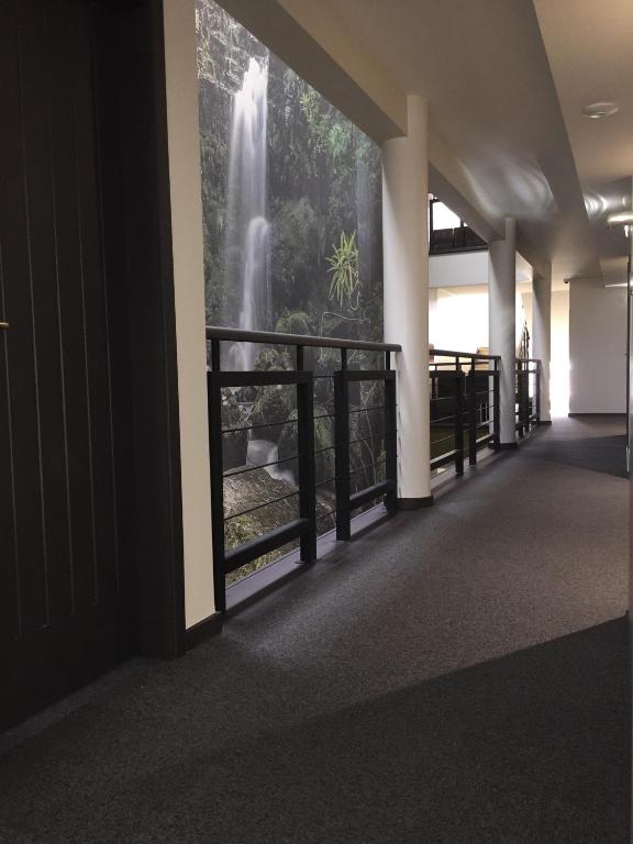 a hallway with a waterfall mural on the wall at Hotel Euro Moniz in Porto Moniz