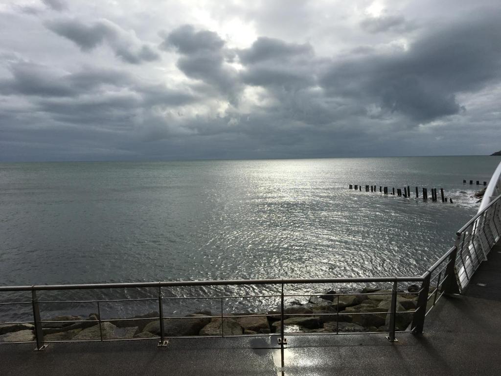 a view of the ocean under a cloudy sky at B2 Waterfoot Apartment in Newcastle