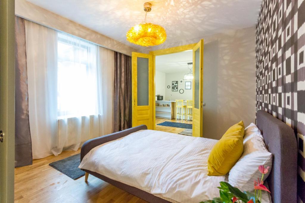 a bedroom with a bed and a yellow light at Quiet Old Town Hideout in Cluj-Napoca