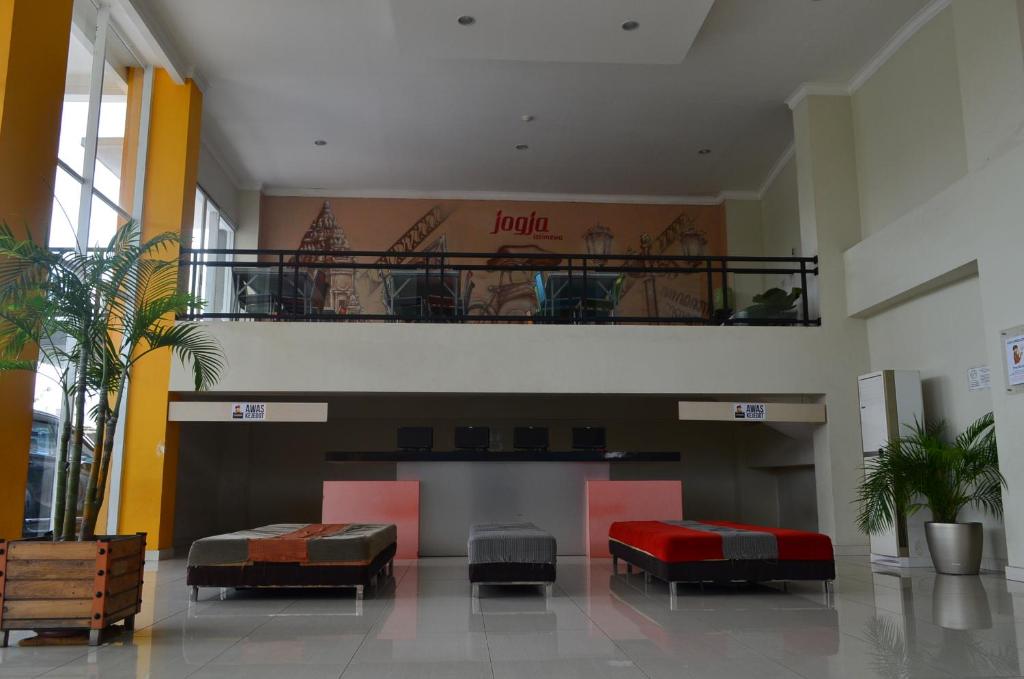a lobby with two beds and a balcony in a building at EDU Hostel in Yogyakarta