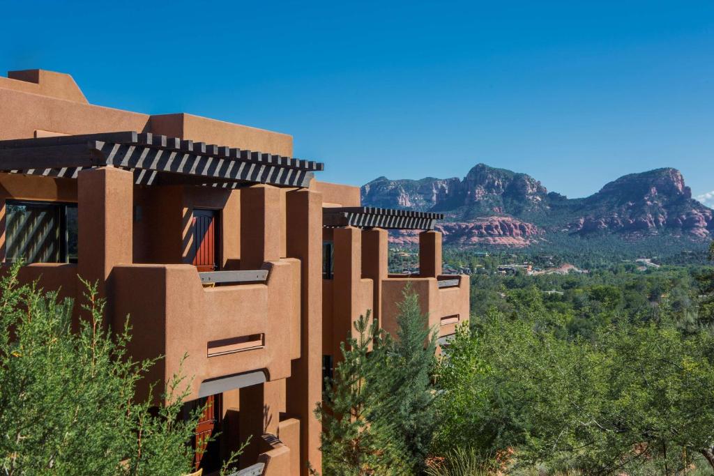 a brown building with mountains in the background at Hyatt Vacation Club at Pinon Pointe, Sedona in Sedona