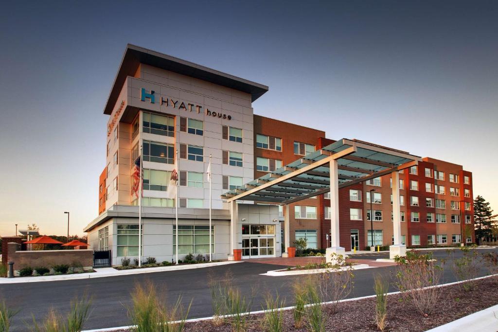 a large building with a parking lot in front of it at Hyatt House Oak Brook in Oak Brook