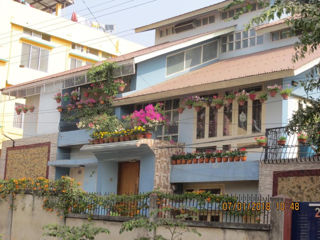 an apartment building with flowers on the balconies at Happy Homes in Guwahati
