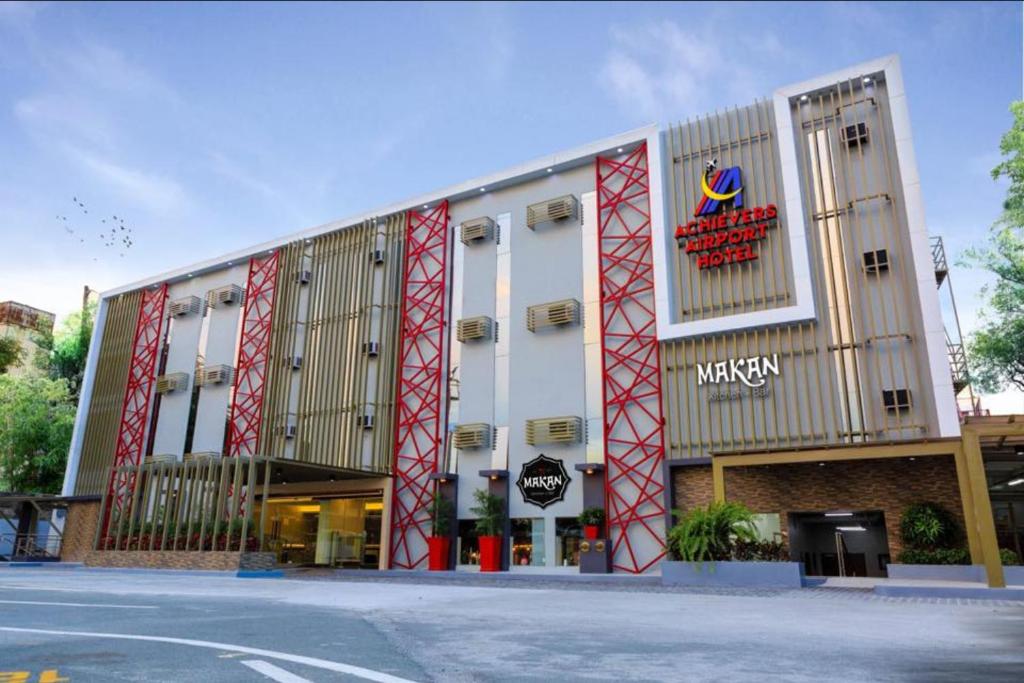 a building with a sign on the side of it at Achievers Airport Hotel in Manila