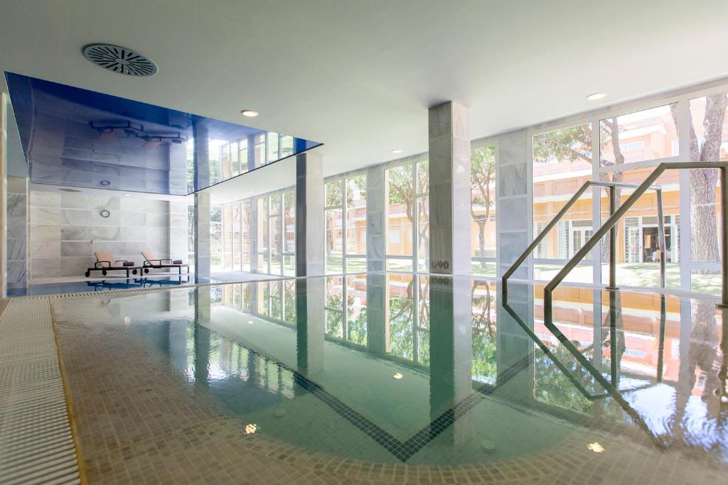 a room with a pool of water in a building at Hipotels Playa La Barrosa - Adults Only in Chiclana de la Frontera