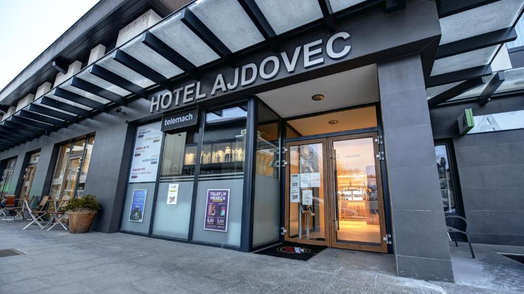a facade of a store with the door open at Hotel Ajdovec in Sevnica