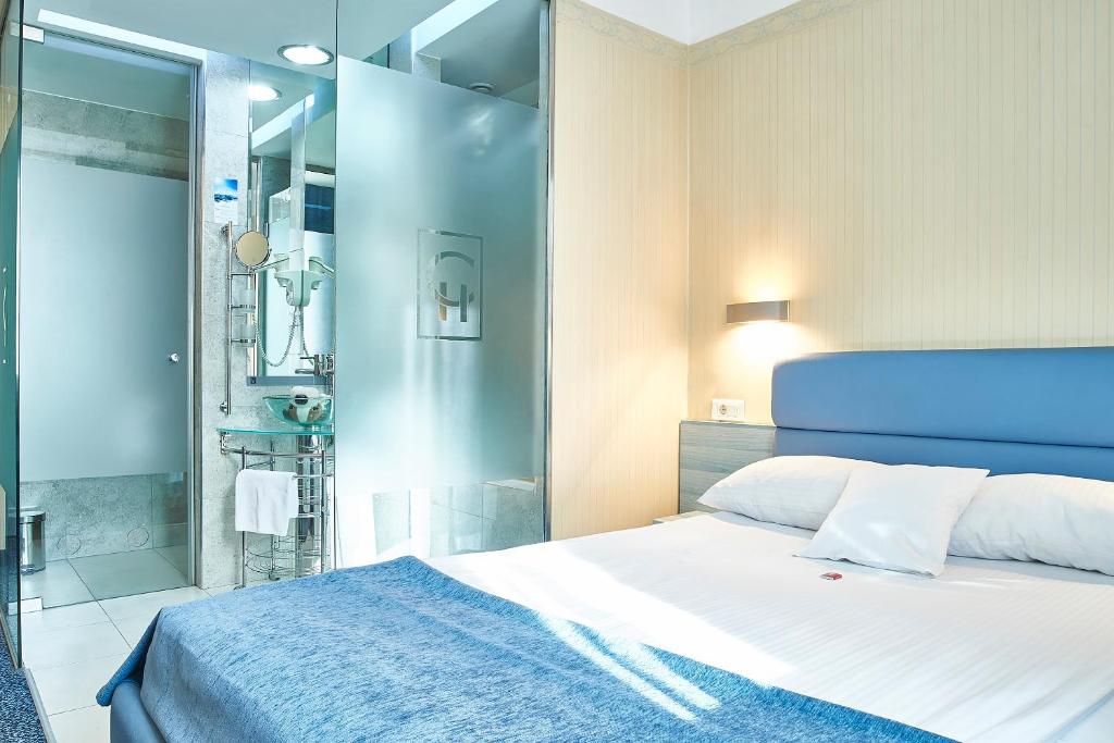 a bedroom with a large bed and a shower at Continental Forum Sibiu in Sibiu