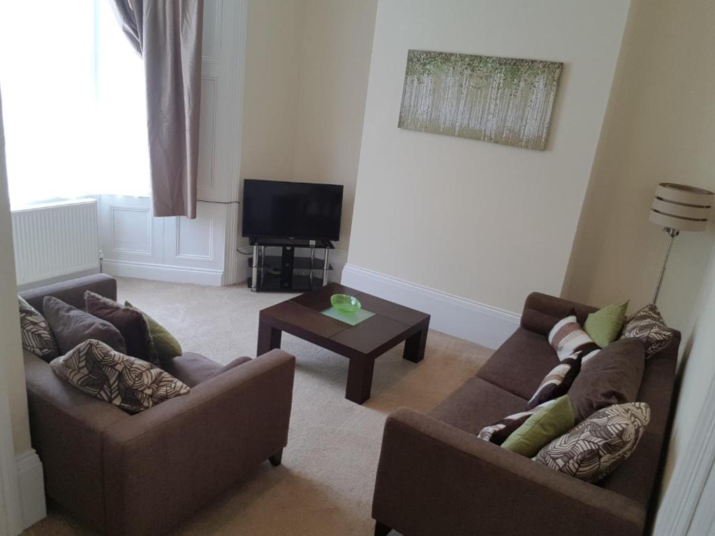 a living room with two couches and a television at Tunstall Serviced Home in Sunderland