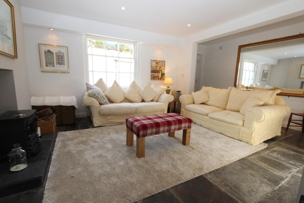 a living room with two couches and a table at Binswood Garden Apartment in Leamington Spa
