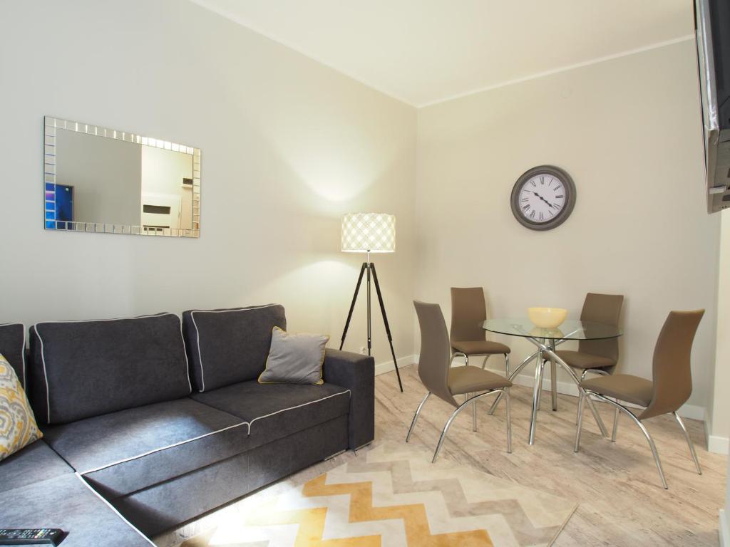 a living room with a couch and a table at Grand-Tourist Old Town Center Apartments in Gdańsk