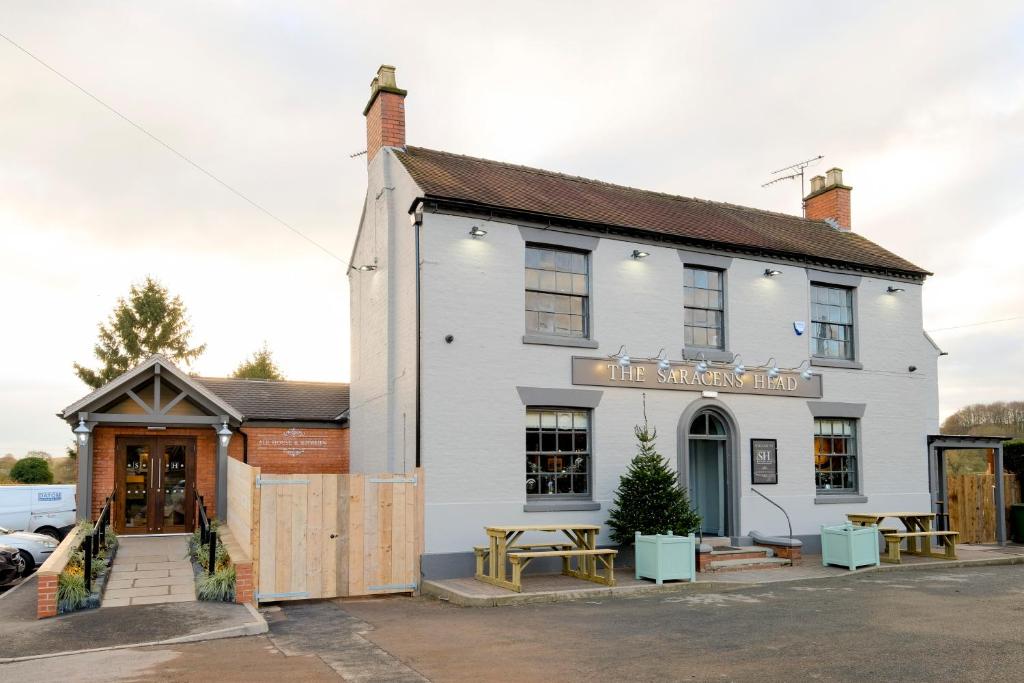 a white building with a table outside of it at The Saracens Head in Stafford