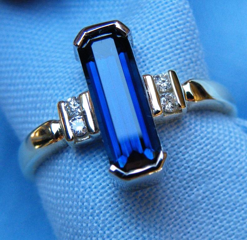 a blue sapphire and two diamonds in a ring at Rubyvale Motel & Holiday Units - An Adults Only Getaway in Rubyvale