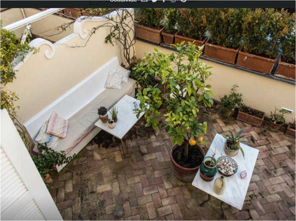 an overhead view of a patio with two tables and plants at Le Camerelle 83 in Capri