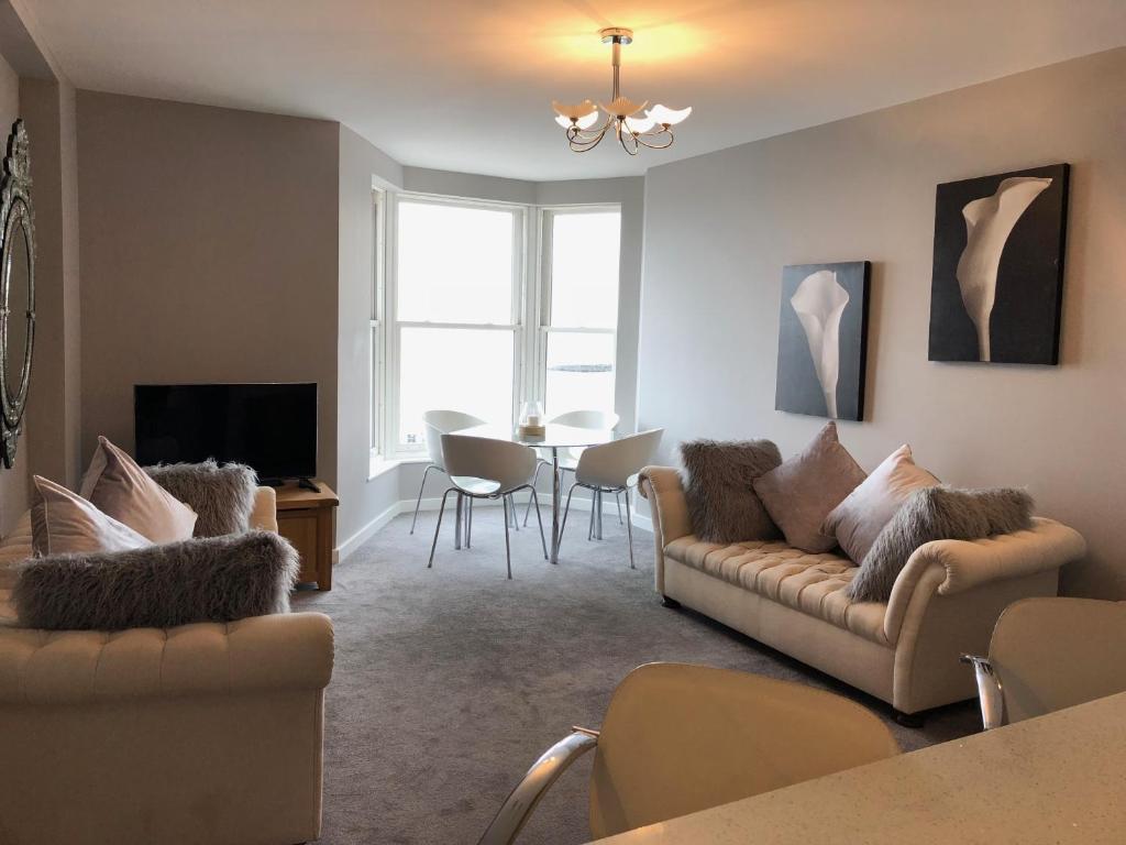 a living room with a couch and a table at Morecambe sea view apartment 203 in Morecambe