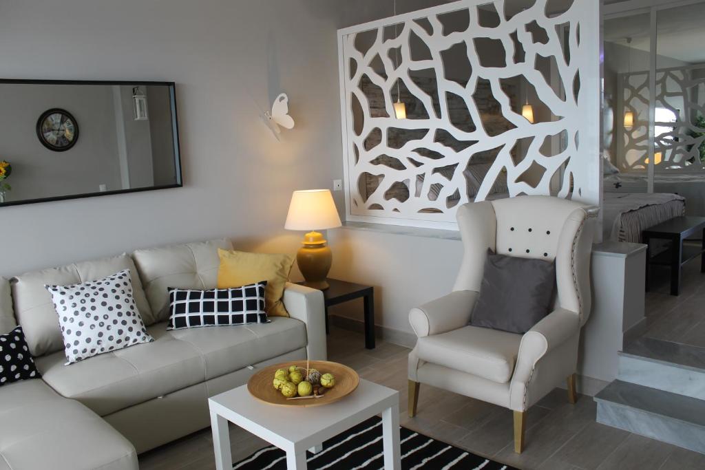 a living room with a couch and a chair at RANCHO MIRAFLORES LUXURY & DESING SEA VIEW in La Cala de Mijas