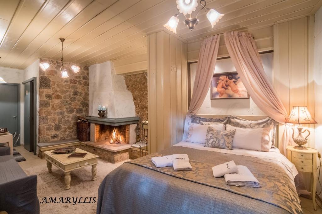 a bedroom with a large bed and a fireplace at Ampolis Guest House in Arachova