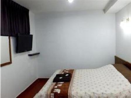 Postel nebo postele na pokoji v ubytování Orchid Inn
