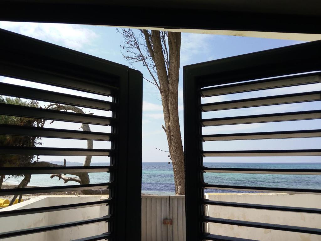 a window view of the ocean from a beach at Appartamenti La Spiaggia in Gallipoli
