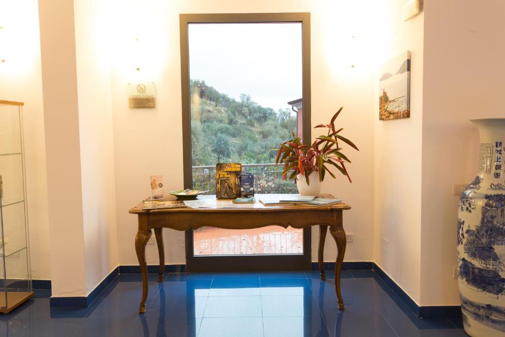 a wooden table in a room with a window at Baia Blu RTA Residence in Lerici