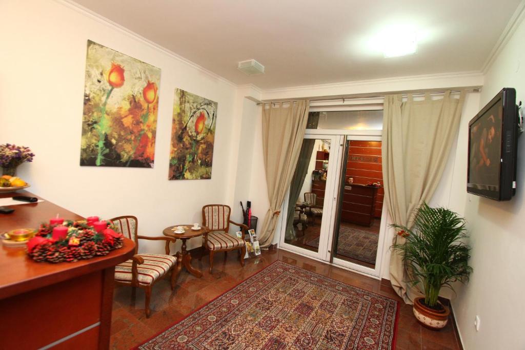 TV a/nebo společenská místnost v ubytování Guesthouse Villa Inn