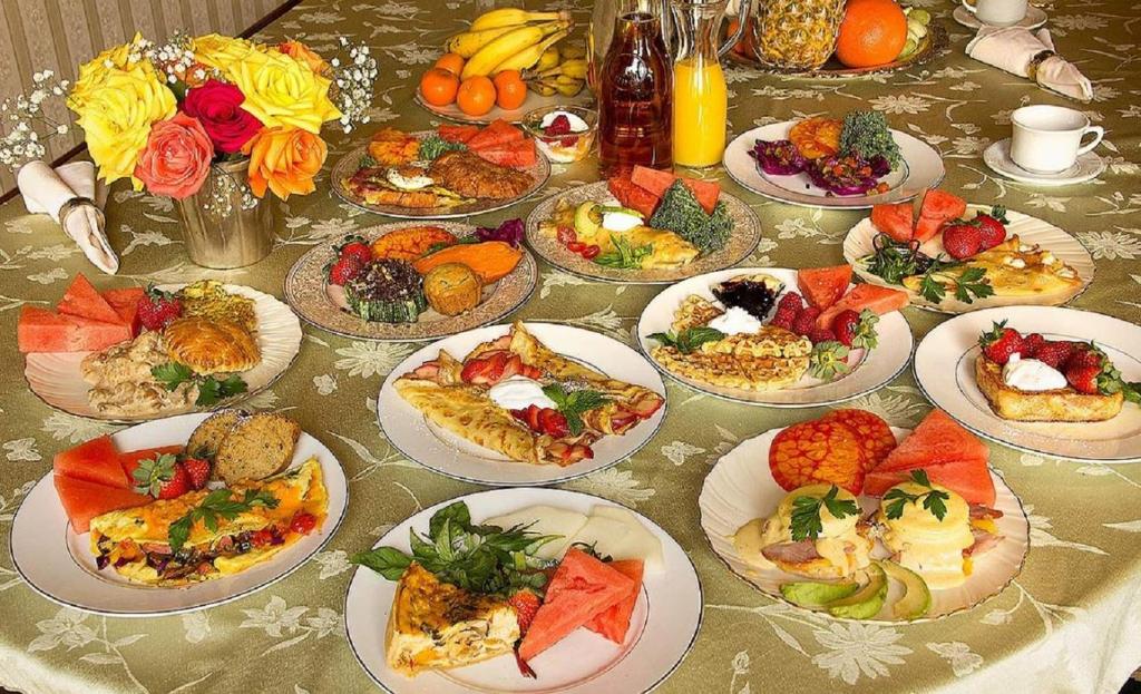 a table with many plates of food on it at Gingerbread Mansion in Ferndale