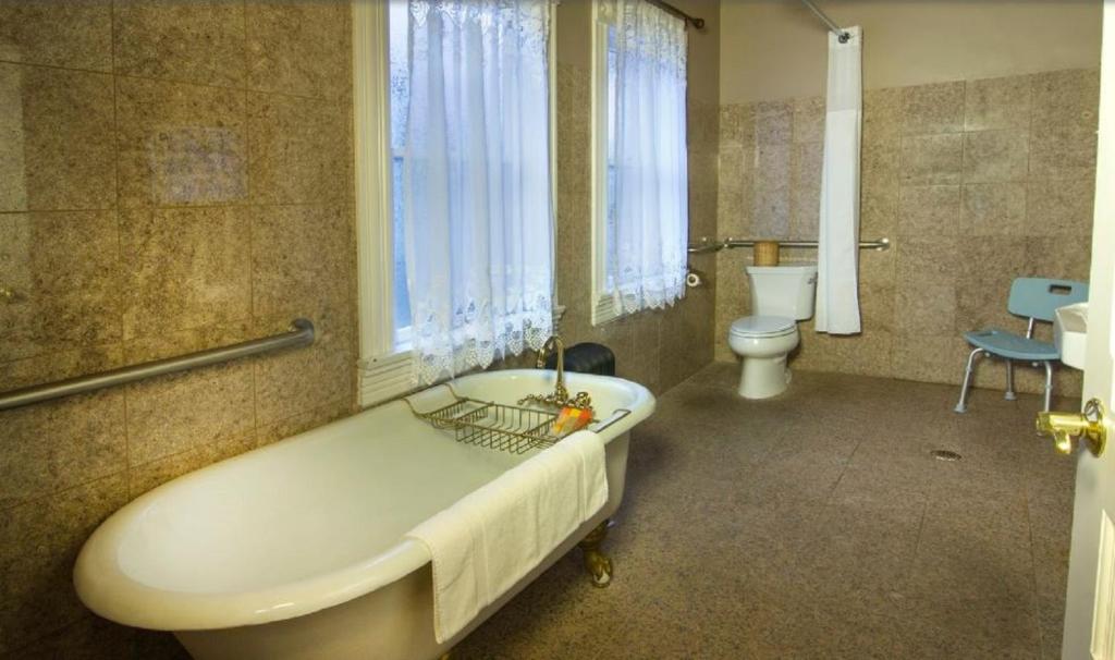 a large bathroom with a tub and a toilet at Gingerbread Mansion in Ferndale