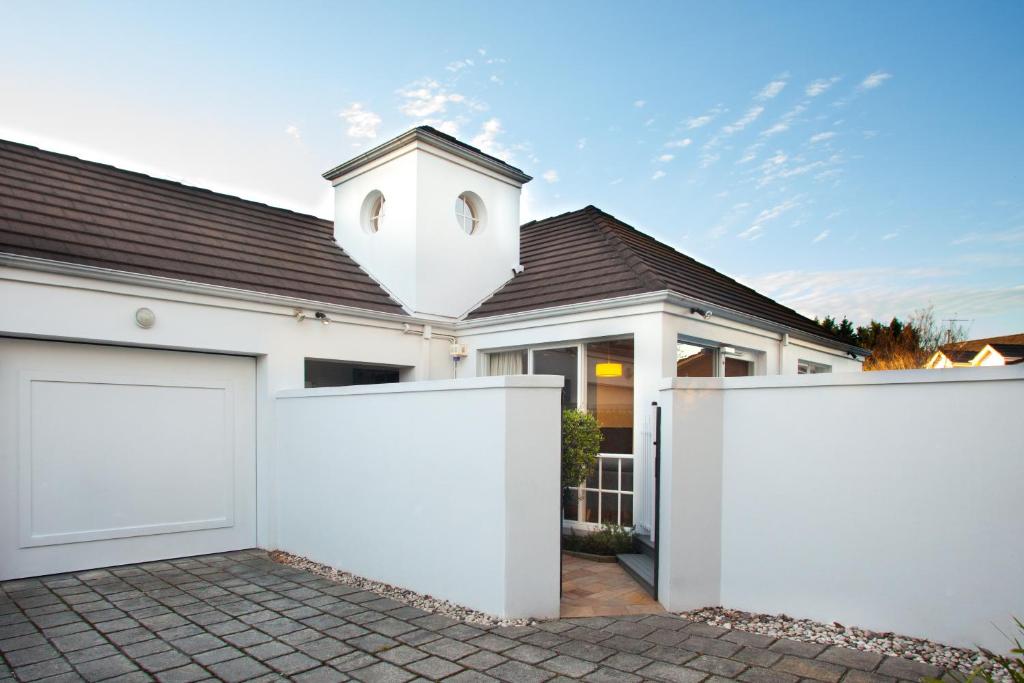 a white fence in front of a house at Brighton House in Melbourne