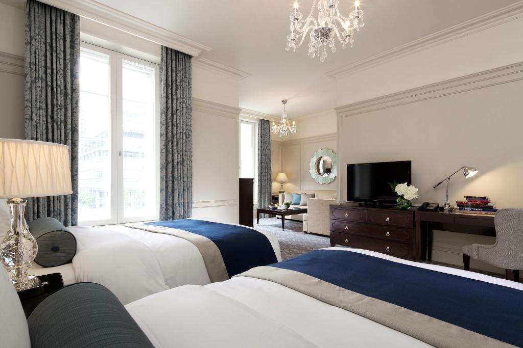 a hotel room with two beds and a television at The Tokyo Station Hotel in Tokyo