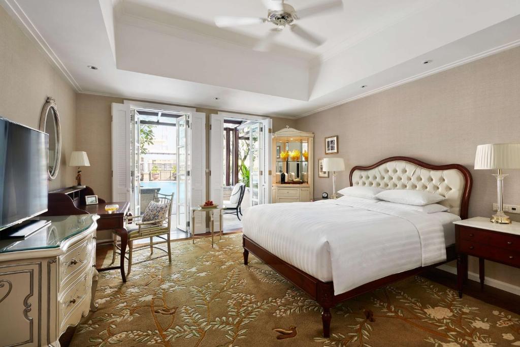a large bedroom with a bed and a television at Park Hyatt Saigon in Ho Chi Minh City