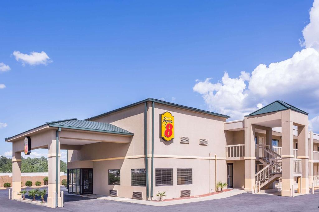 a hotel exterior with a fast food restaurant at Super 8 by Wyndham Macon West in Macon