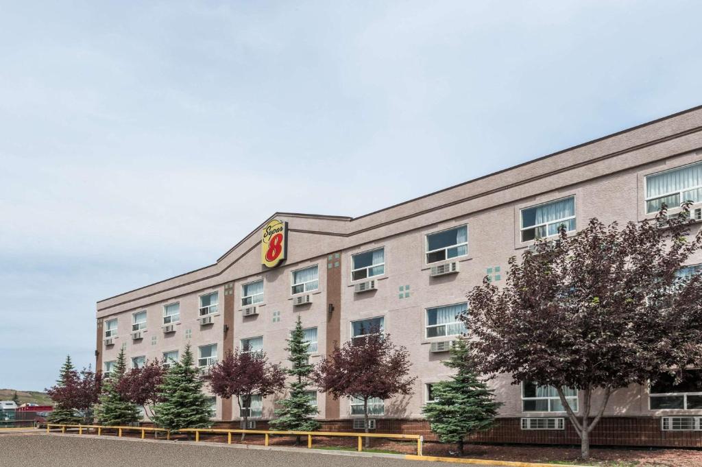 a building with a sign on the side of it at Super 8 by Wyndham Edmonton/West in Edmonton