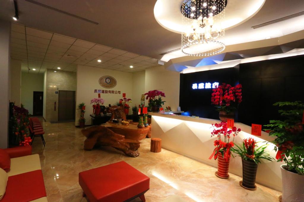 a lobby with a flower shop with plants and a chandelier at ChangJu Hotel in Taitung City