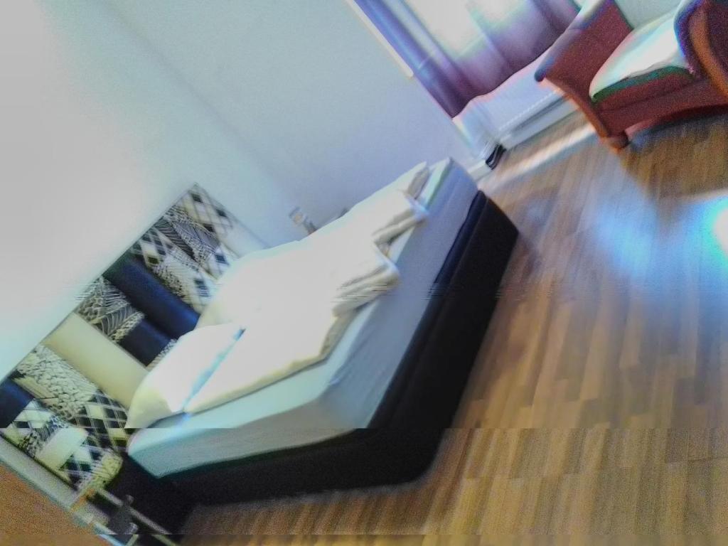 a bedroom with a bed with white pillows at Zimmer in Kaiserslautern in Kaiserslautern