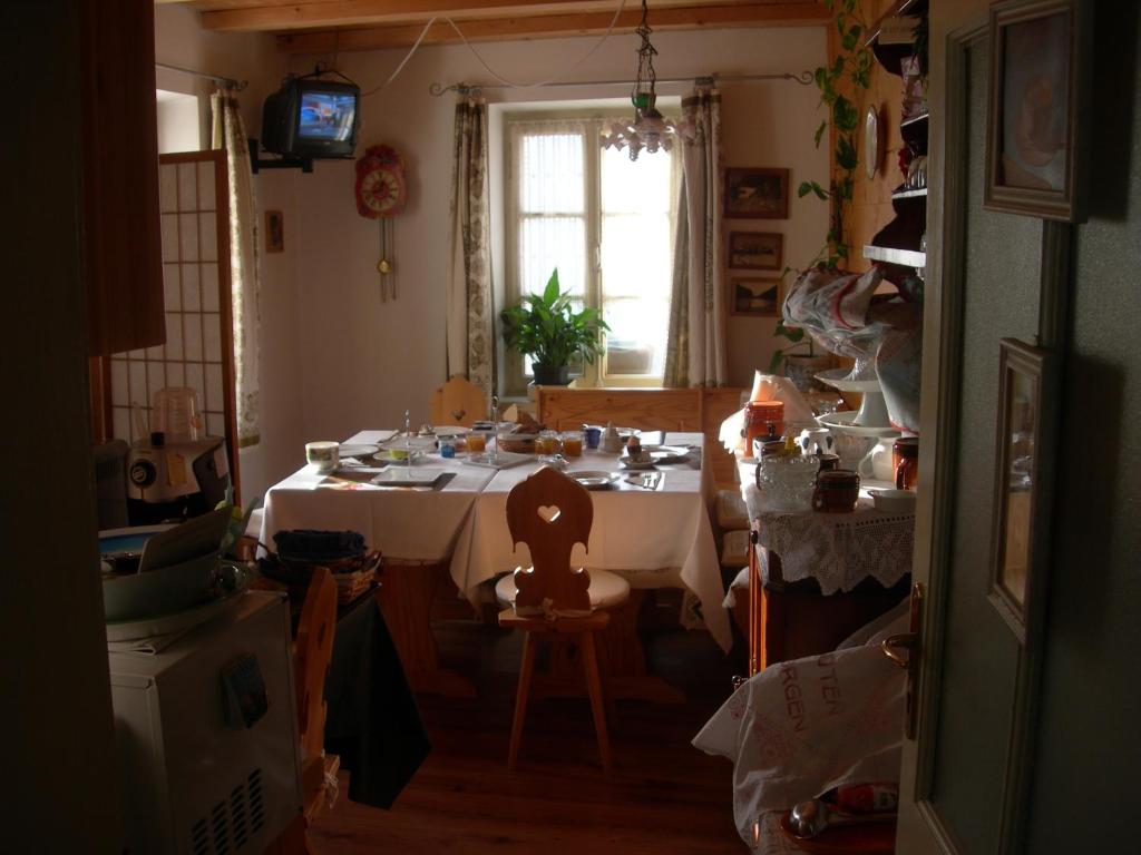 a kitchen with a white table and a window at B&B Airone in Venas