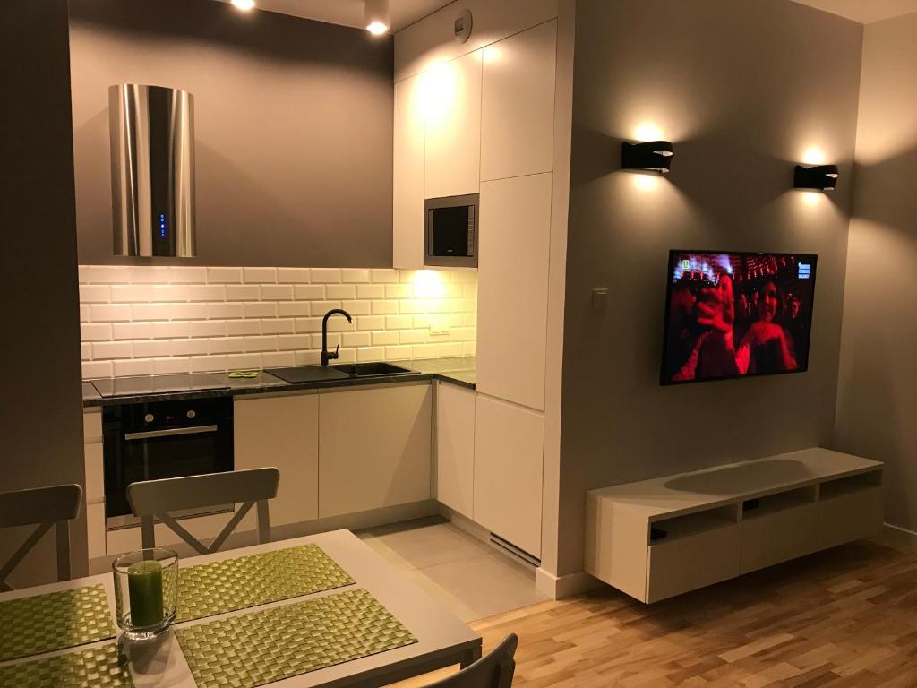 Televízia a/alebo spoločenská miestnosť v ubytovaní Millennium Awangarda Green