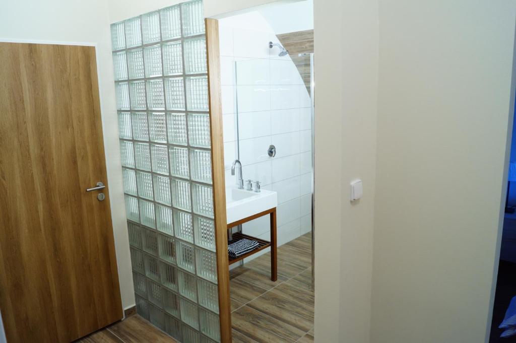 a bathroom with a sink and a mirror at Apartmány u komína in Terezín