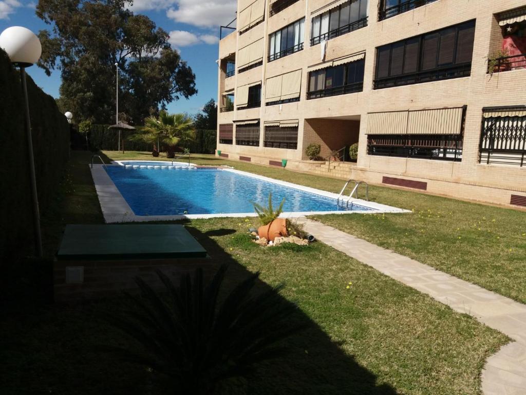 a swimming pool in front of a building at 2º Linea de Playa, Barcelona in La Venteta