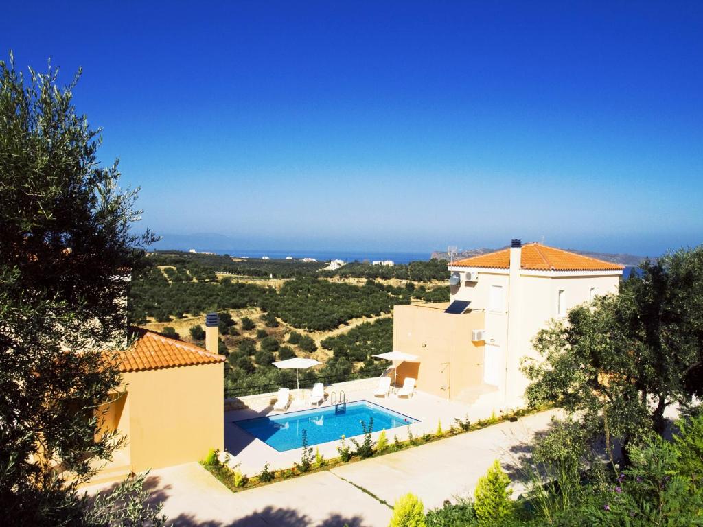 an aerial view of a villa with a swimming pool at Olive Tree Hillside Apartment in Stalos