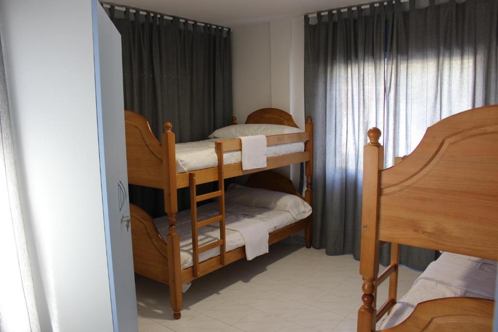 a bedroom with two bunk beds and a window at A Senda in Caldas de Reis