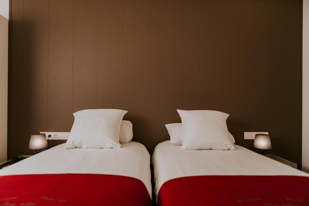 Postel nebo postele na pokoji v ubytování Hotel New Regina