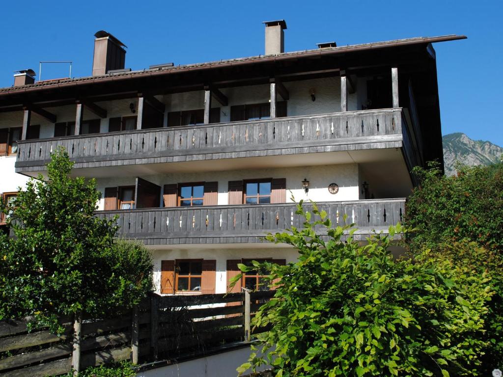 a building with a balcony on the side of it at Premium-Chalet Achental mit Kamin und Sauna in Schleching