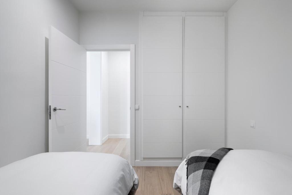 Postel nebo postele na pokoji v ubytování Principe de Vergara Apartment II by Flatsweethome