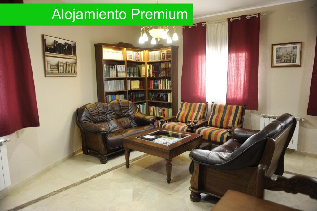 a living room with two couches and a coffee table at Casa Rural La Biblioteca in Almagro