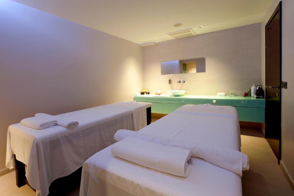 a hospital room with two beds and a sink at Hotel Parentium Plava Laguna in Poreč