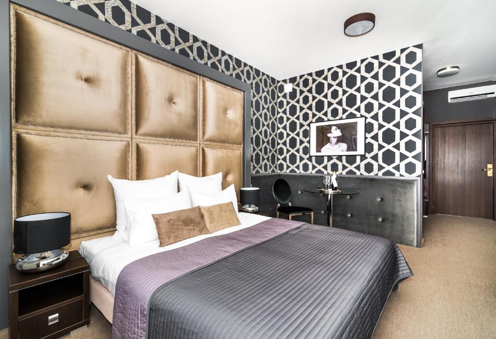Posteľ alebo postele v izbe v ubytovaní Hotel Luxor