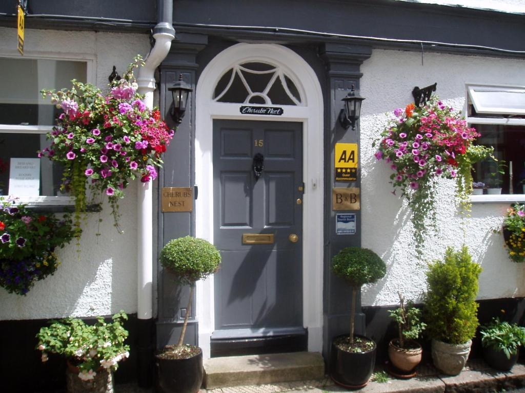 a front door of a house with potted plants at Cherubs Nest in Dartmouth