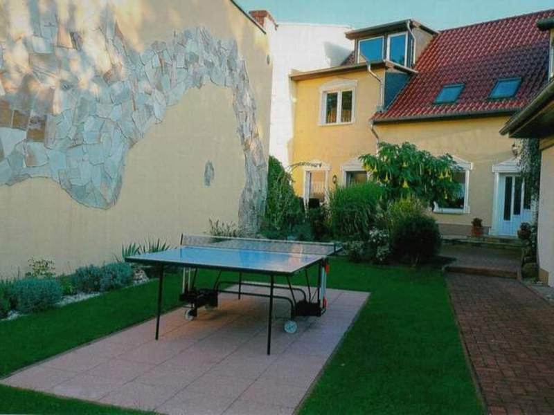 a ping pong table in front of a house at Ferienwohnung Familie Knak in Lassan