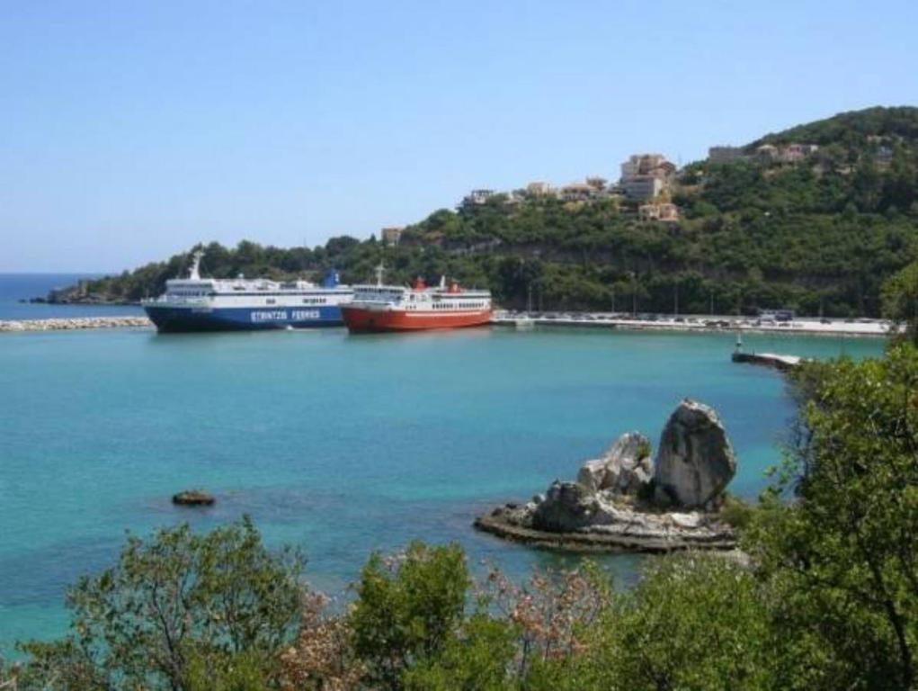 two boats are docked in a large body of water at Kristi in Póros Kefalonias